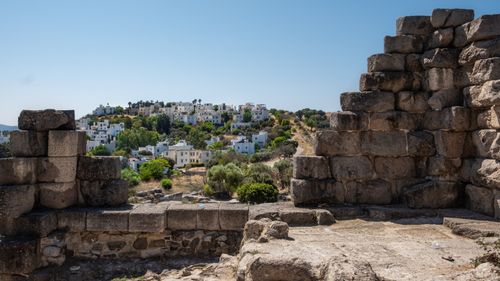 Free View from ancient ruins in Bodrum, Türkiye featuring stone walls and a hillside with white houses. Stock Photo