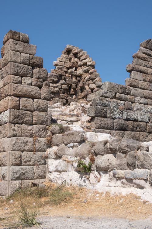 Free Ancient stone ruins under a clear blue sky in Muğla, Türkiye, showcasing historical architecture. Stock Photo