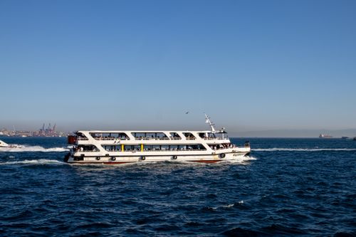 Free A ferry sails across the Bosphorus under a clear blue sky in İstanbul, Türkiye. Stock Photo