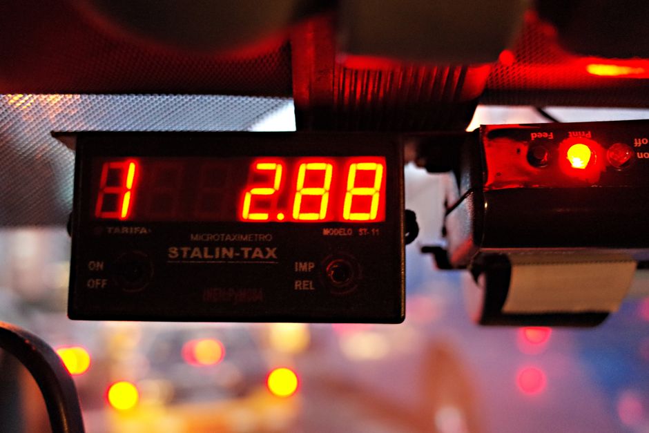 Close-up of an illuminated taxi meter reading '2.88' during nighttime inside a vehicle.
