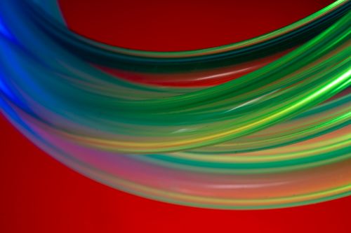 Free Colorful abstract image with glowing light streaks in green and blue against a vivid red background. Stock Photo