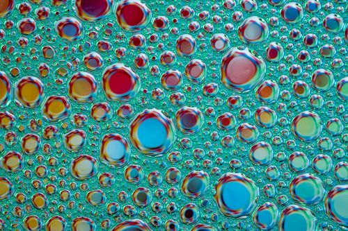 Free A vibrant macro capture of colorful soap bubbles forming an abstract pattern. Stock Photo