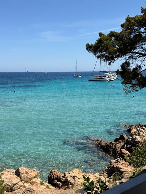 Free Idyllic coastal scene in Porto Cervo, Sardinia, featuring turquoise waters and anchored boats. Stock Photo