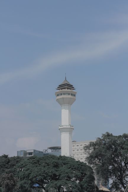 A towering minaret rises against a clear sky, showcasing architectural beauty and serenity.