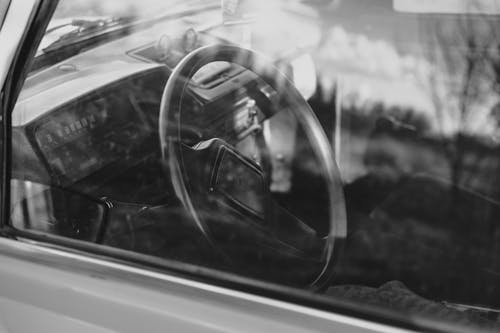 Grayscale Photo of a Steering Wheel