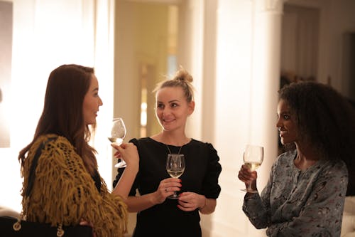 3 Women Holding Clear Drinking Glass