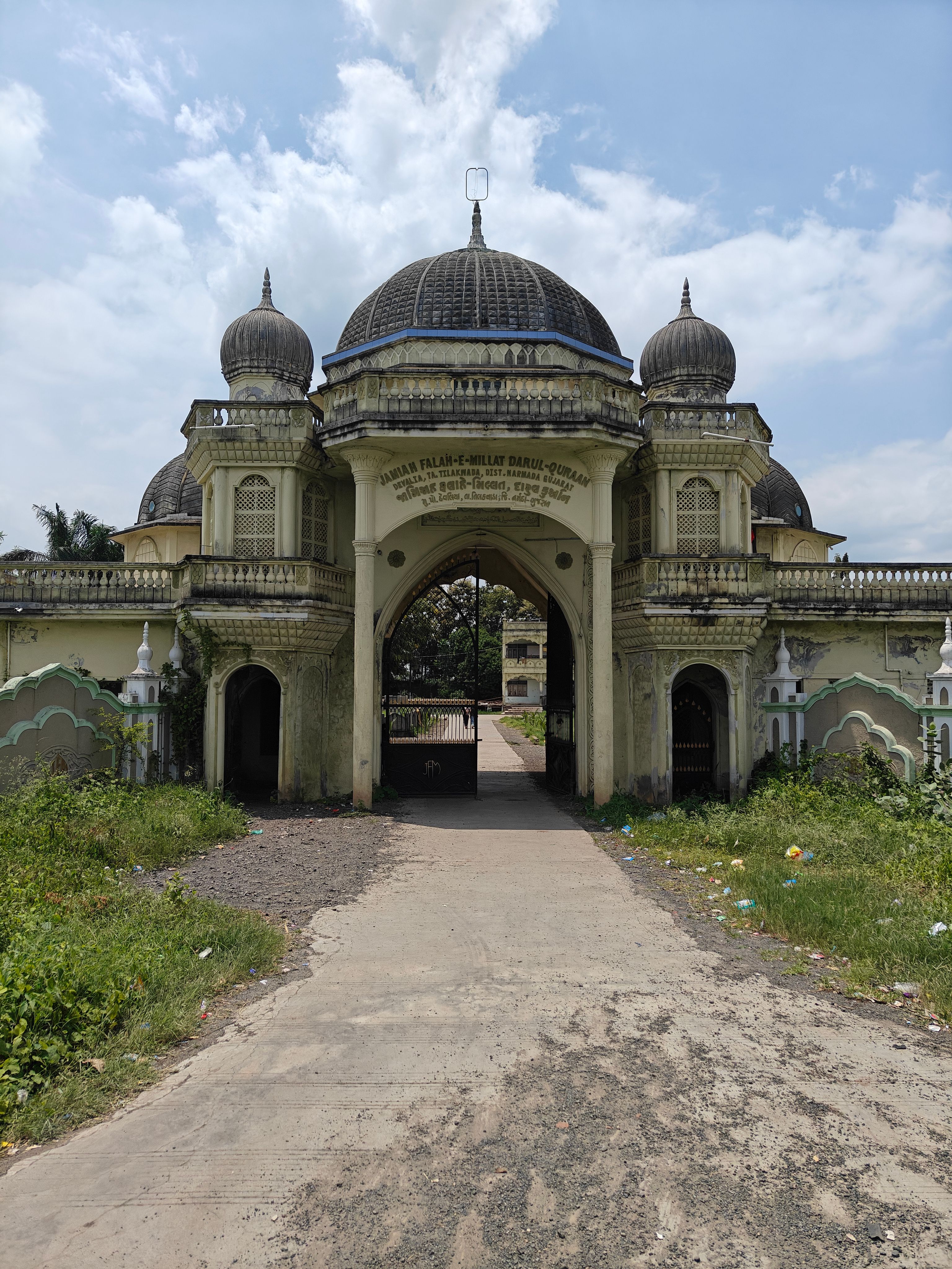 Explore historic Indo-Islamic architecture in an open setting, showcasing grand arches and domes.