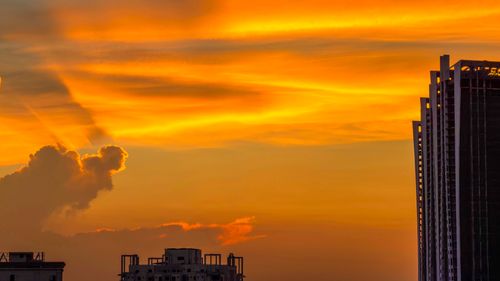Free A stunning sunset with vivid orange clouds over a modern cityscape, reflecting urban beauty and tranquility. Stock Photo
