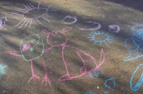 Free Charming chalk drawing of animals and sun on outdoor pavement, exuding creativity. Stock Photo
