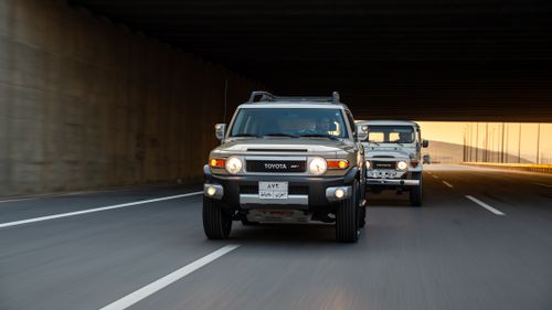 Free Two Toyota SUVs driving on a highway through a tunnel during the day. Stock Photo