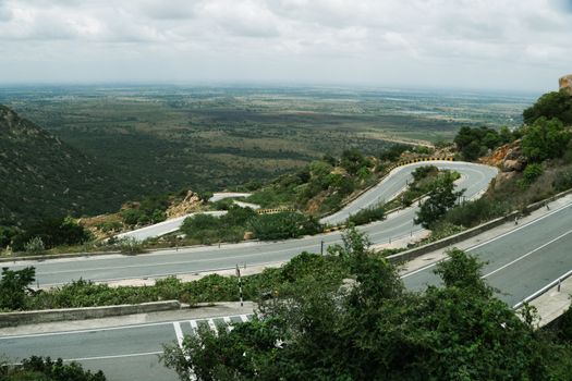 Aerial view of the twisty roads surrounded by lush greenery in the hills of Bengaluru, Karnataka.