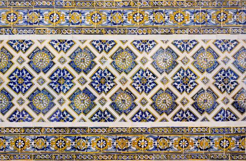 Free Detailed image of a traditional Portuguese azulejo tile pattern with blue and yellow motifs. Stock Photo