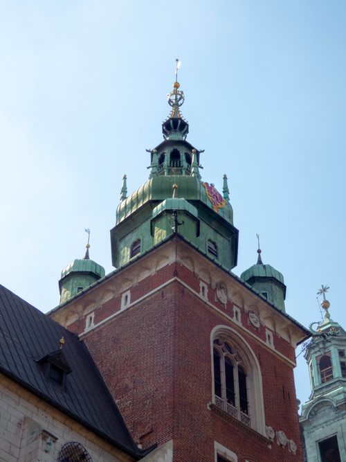 Free A close-up view of St. Mary's Basilica tower under a clear blue sky in Cracow, Poland. Stock Photo