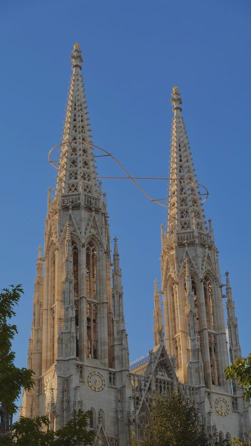 Free A stunning view of the Votivkirche spires in Vienna, Austria, against a clear blue sky. Stock Photo