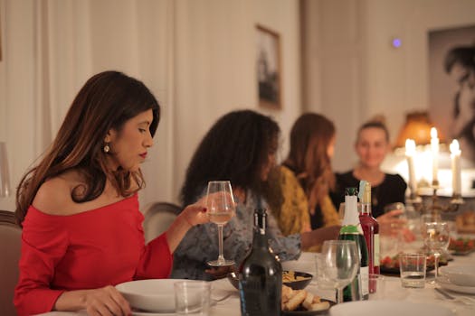 A group of women enjoying a candlelit dinner indoors, celebrating friendship.