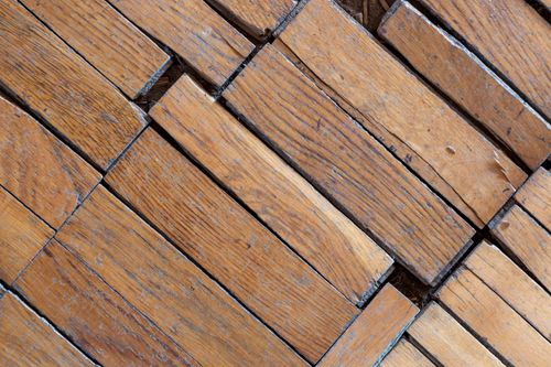 Free Detailed view of aged and textured wooden floorboards with visible grain and weathering. Stock Photo