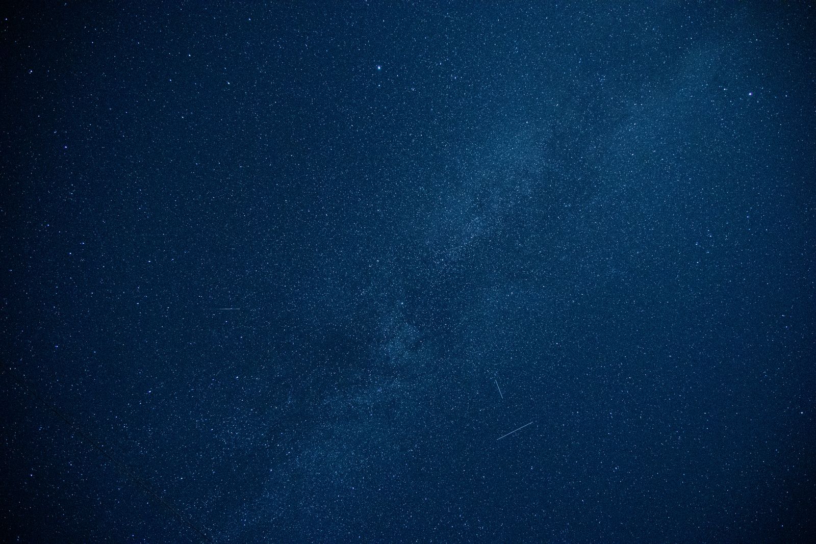Night sky showcasing a Milky Way galaxy and bright stars.