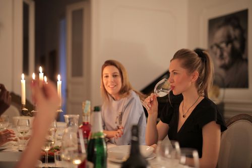 Free Warm candlelit dinner with friends enjoying wine and conversation. Stock Photo