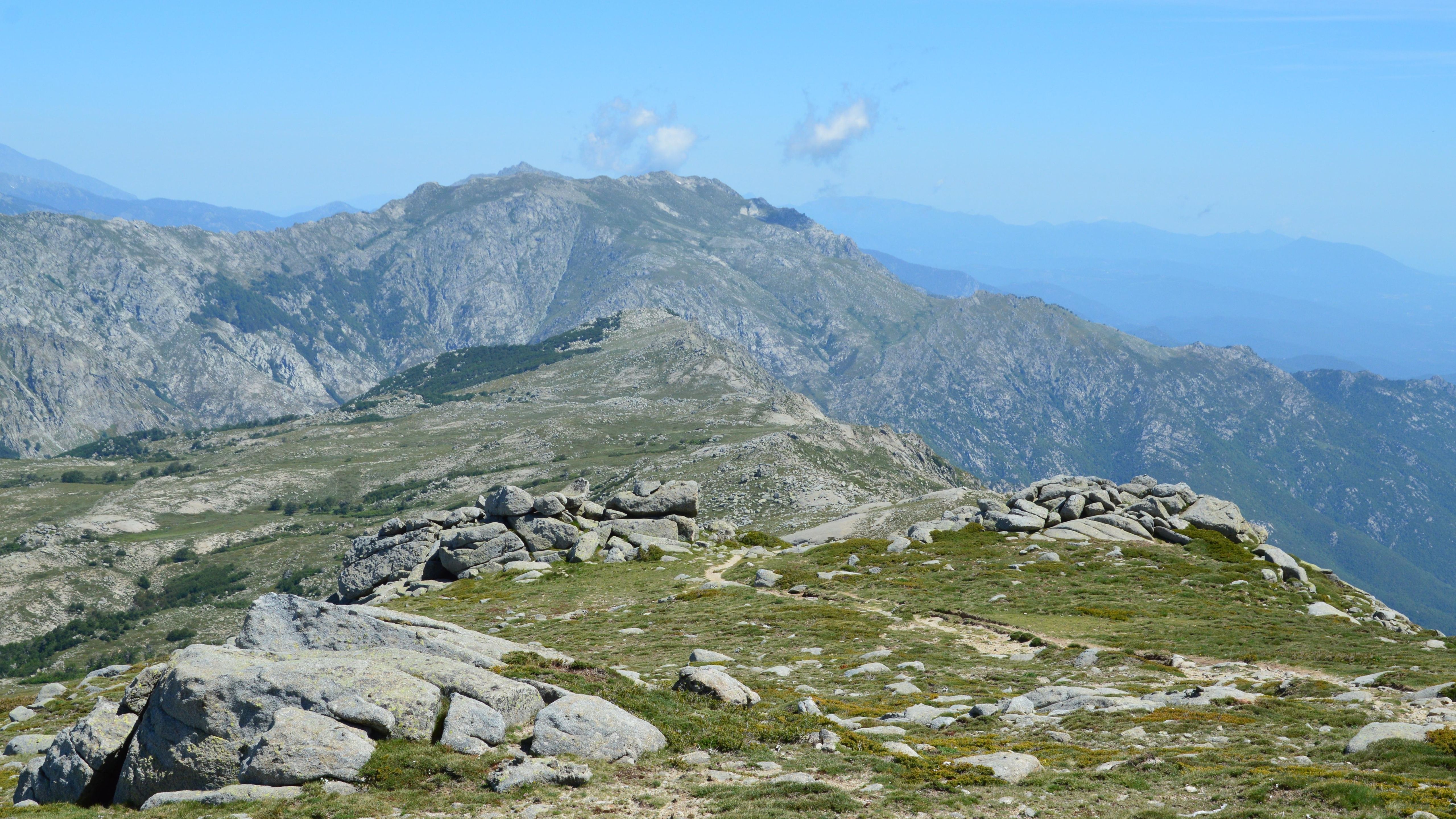 Beautiful view of rocky mountain terrain and blue sky in Aullène, Corsica.