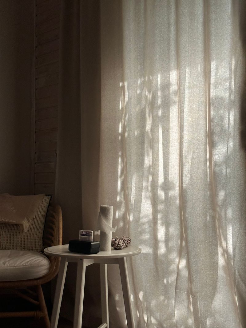 A quiet sunlit room with curtains and a chair — Zmaysq on Pexels