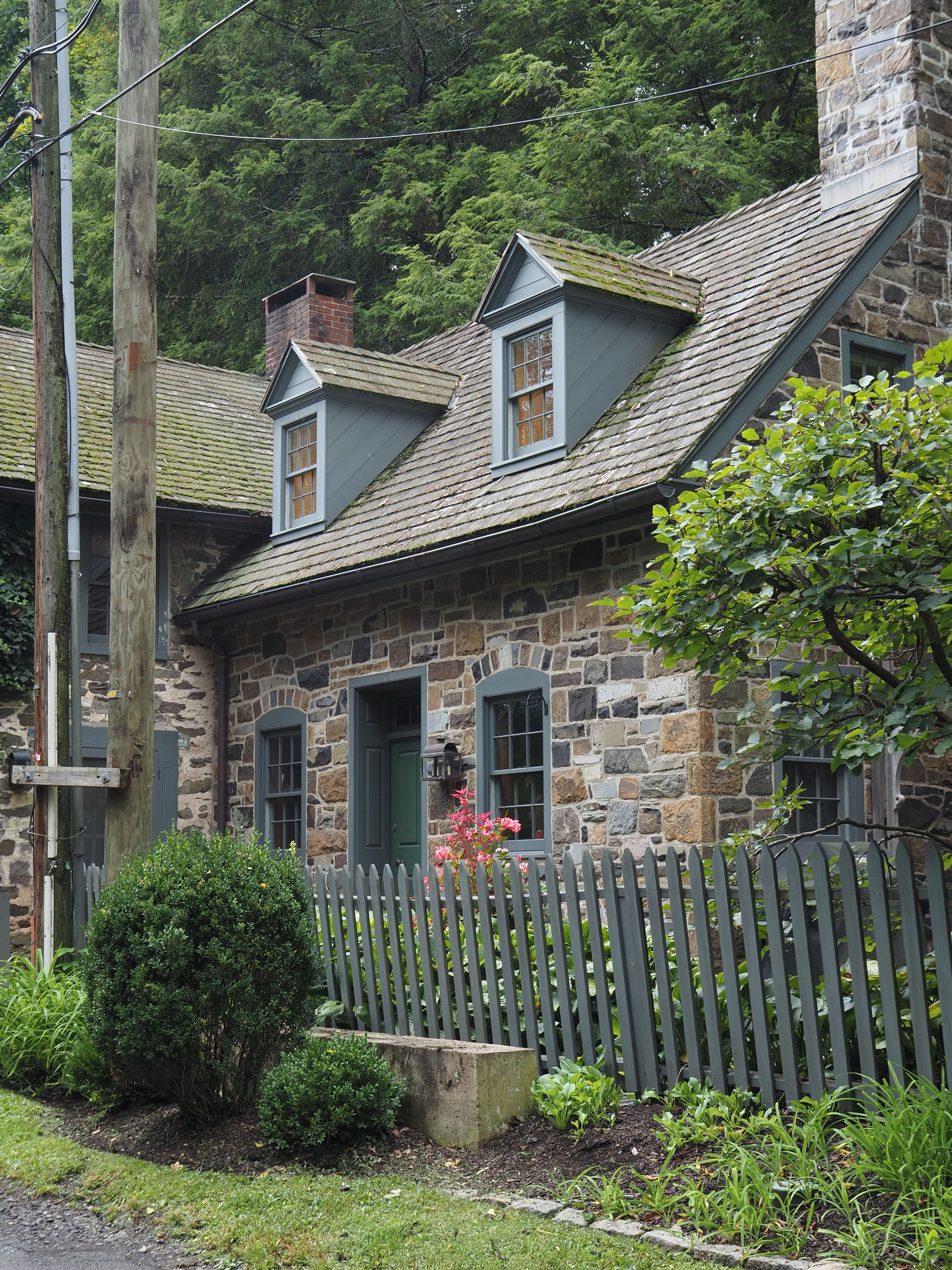 Fieldstone house set among lush greenery in rural Pennsylvania, the classic stone home style found around Glen Mills