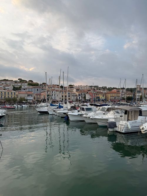 Free Charming view of Cassis harbor with boats and colorful buildings at dusk. Stock Photo