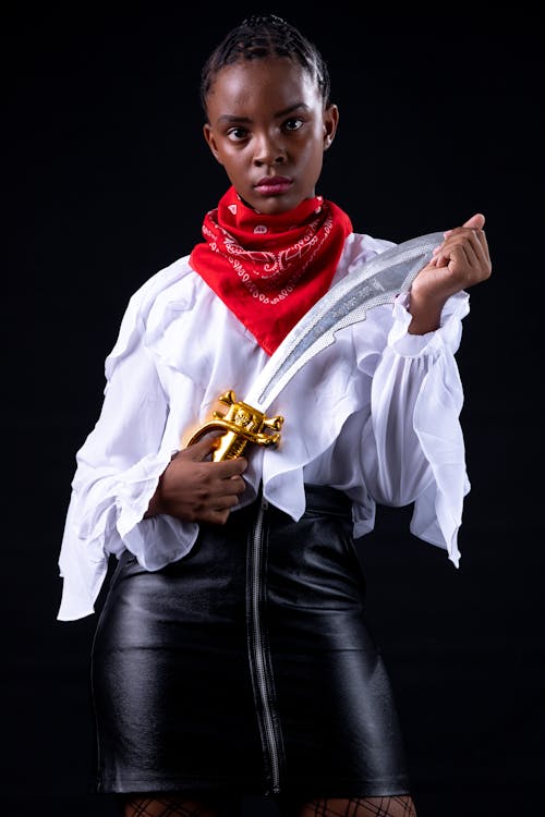 Woman In White Long Sleeve Shirt Holding A Sword