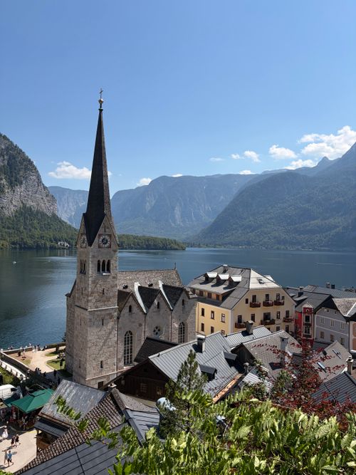 Free Picturesque view of Hallstatt village with its iconic church, waterfront, and mountain backdrop. Stock Photo