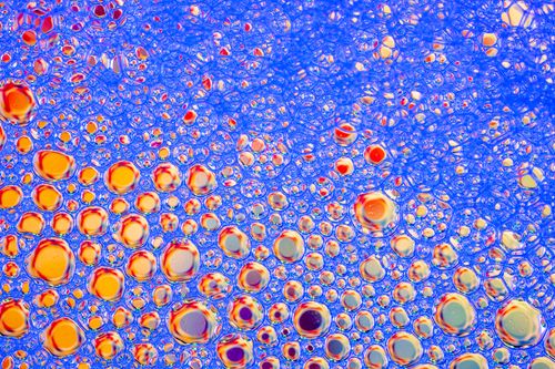Free Colorful abstract macro shot of soap bubbles creating an intricate pattern. Stock Photo