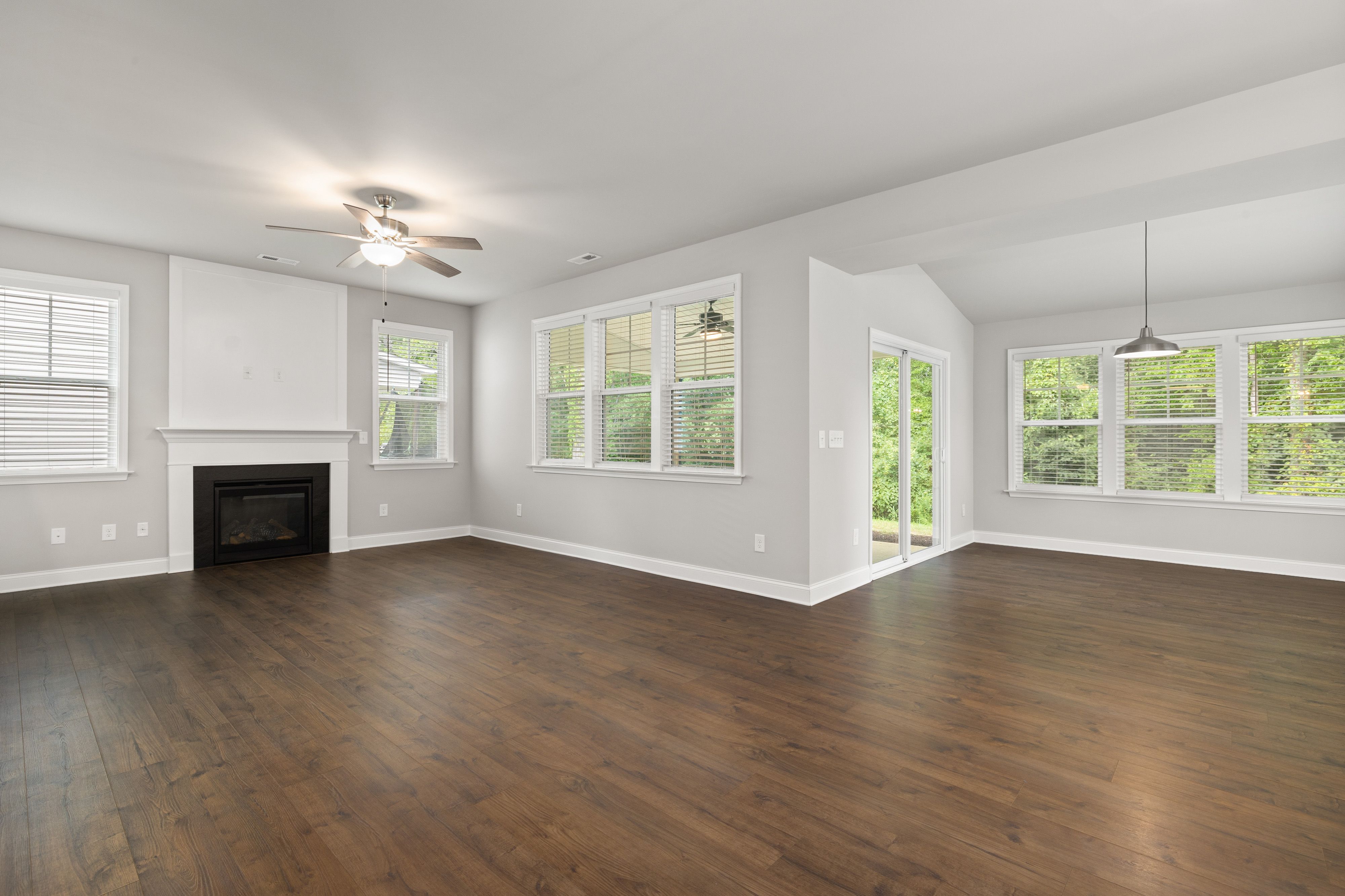 Flooring specialist installing hardwood planks in a residential living space