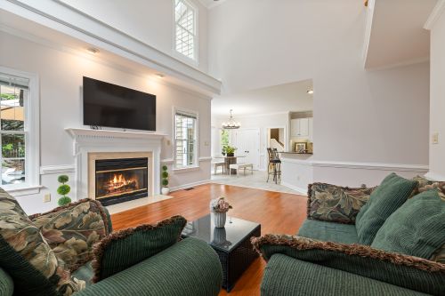 Free Elegant living room featuring a warm fireplace, modern decor, and a comfortable sofa. Stock Photo