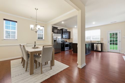 Free Spacious open-plan dining area with contemporary furniture and modern kitchen in a bright setting. Stock Photo
