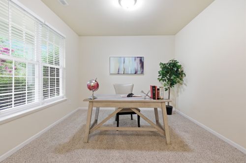 Free Bright and airy home office with a modern minimalist design, featuring a desk, globe, bookshelf, and natural light. Stock Photo