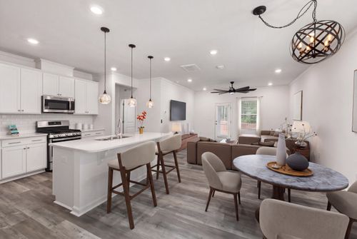 Free Contemporary open-plan kitchen and living room with modern decor and lighting. Stock Photo
