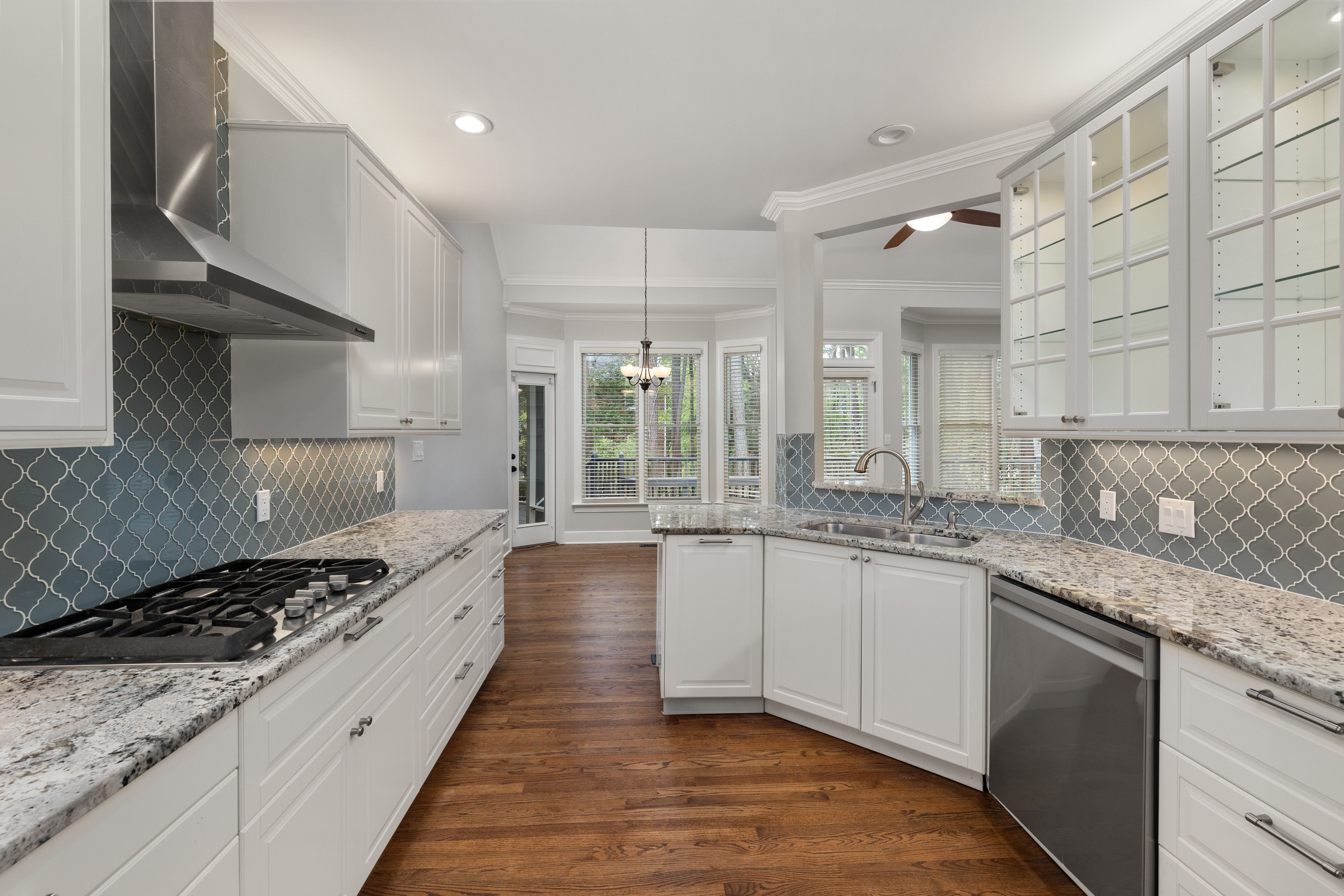 Spacious kitchen featuring granite countertops, hardwood floors, and elegant cabinets.