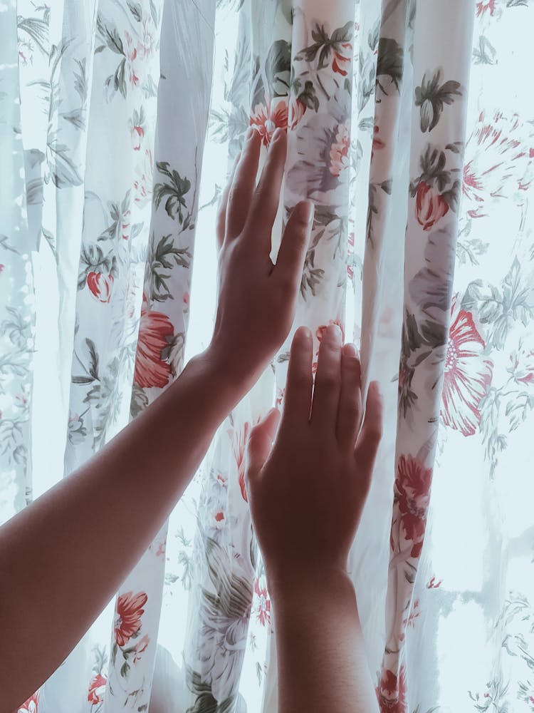 Photo Of Person Touching Curtains