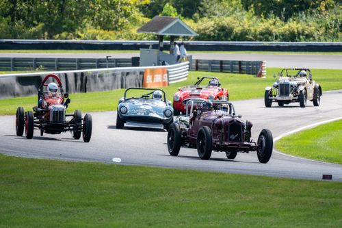Free Historic car race on an outdoor track in Salisbury, Connecticut, featuring vintage sports cars in action. Stock Photo