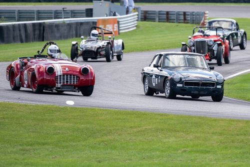 Free Capture of a vintage car race featuring classic convertibles on a track in Salisbury, Connecticut. Stock Photo