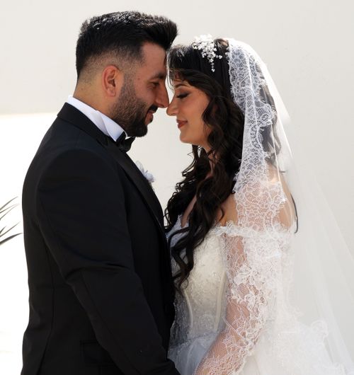 Free A bride and groom lovingly embrace during their wedding ceremony outdoors. Stock Photo