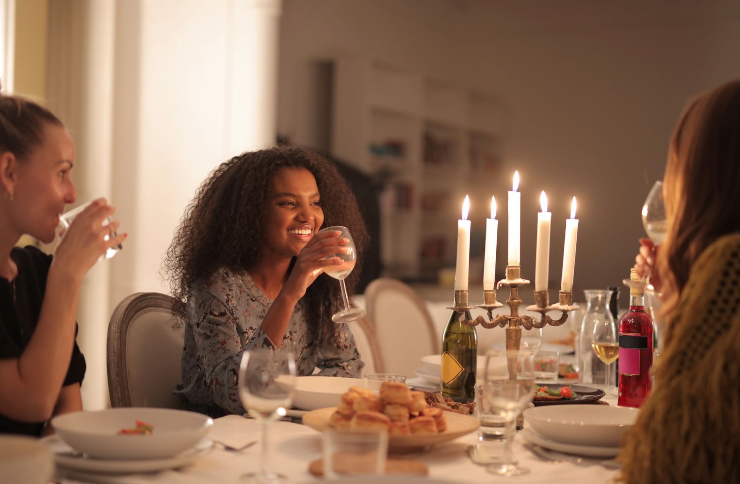 Friends enjoying an elegant private candlelit dinner party