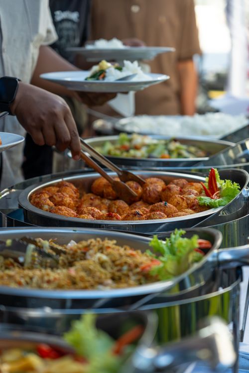 Free An appetizing buffet spread featuring various dishes at an outdoor event, highlighting culinary diversity. Stock Photo