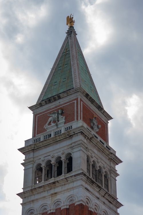 Free A detailed view of the iconic St Mark's Campanile in Venice, Italy, captured under a dramatic sky. Stock Photo