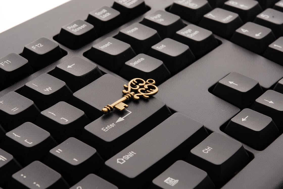Brass Ornate Vintage Key on Black Computer Keyboard