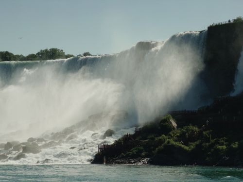 Free Breathtaking capture of Niagara Falls showcasing cascading water and mist under a clear sky. Stock Photo