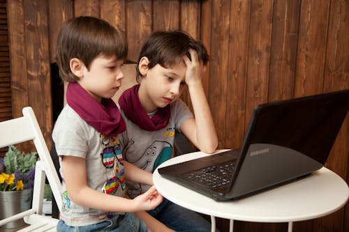 Free Boys Looking At Computer Screen Stock Photo