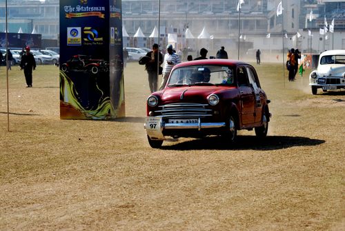 Free Vintage cars participate in an outdoor rally event, showcasing classic automobile designs. Stock Photo