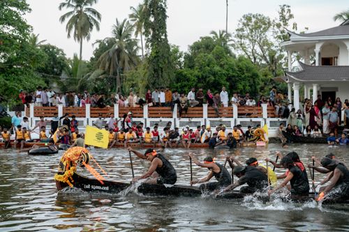 Free Exciting traditional boat race in Kumarakom, Kerala surrounded by cheering crowds. Stock Photo