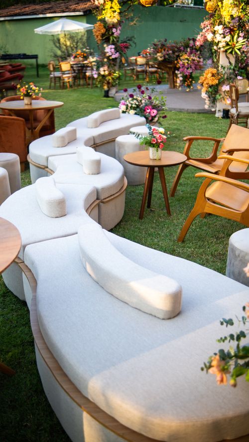Free Elegant outdoor seating arrangement with floral decor and natural lighting. Stock Photo