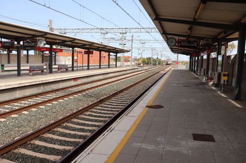 Free A deserted train platform at Puerto Real station in Andalusia, Spain, under a clear sky. Stock Photo