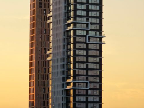Free Silhouetted view of modern skyscrapers against a vibrant sunset sky. Stock Photo